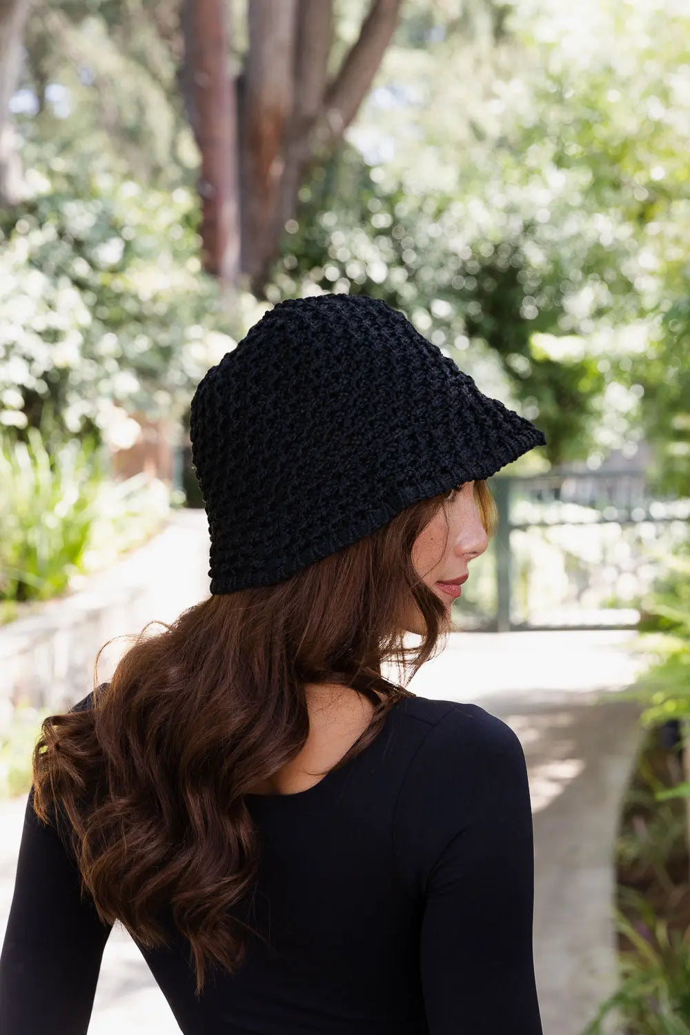 Black handwoven crochet bucket hat side view with wide brim and textured stitch