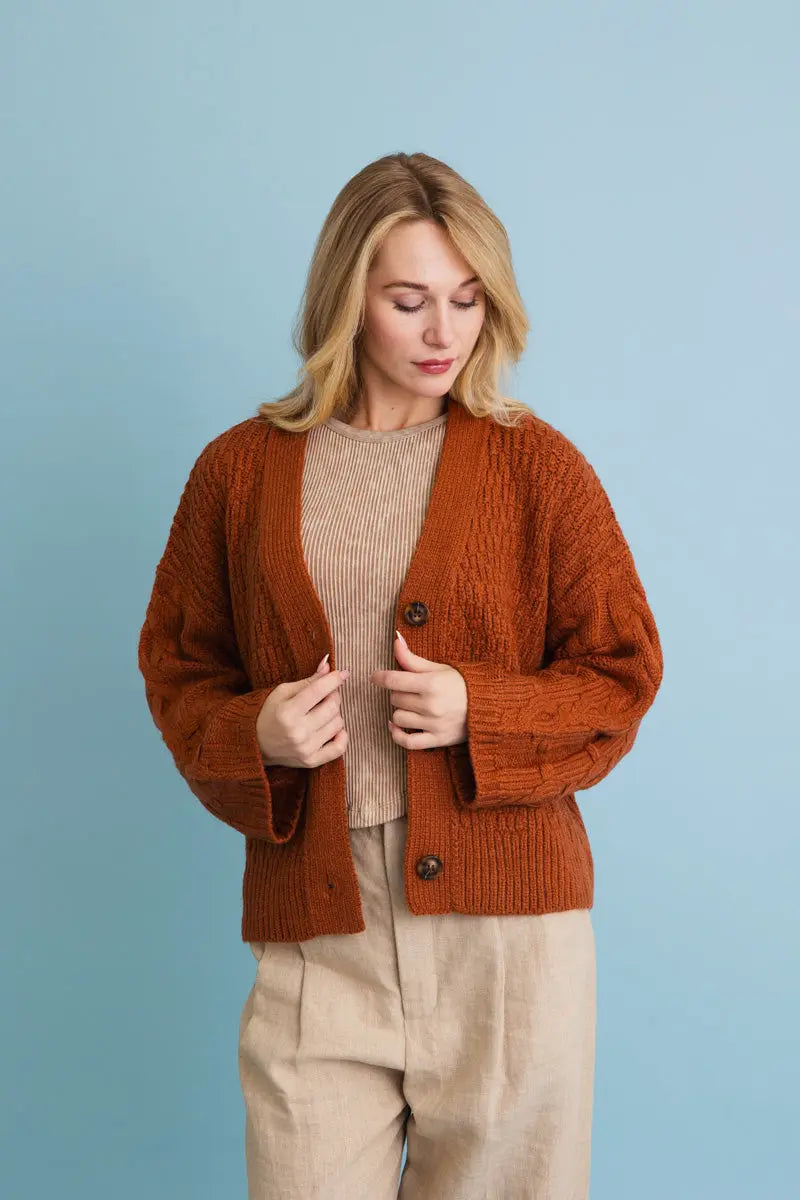 Brown/orange textured knit cardigan with button-front and long sleeves; front view.