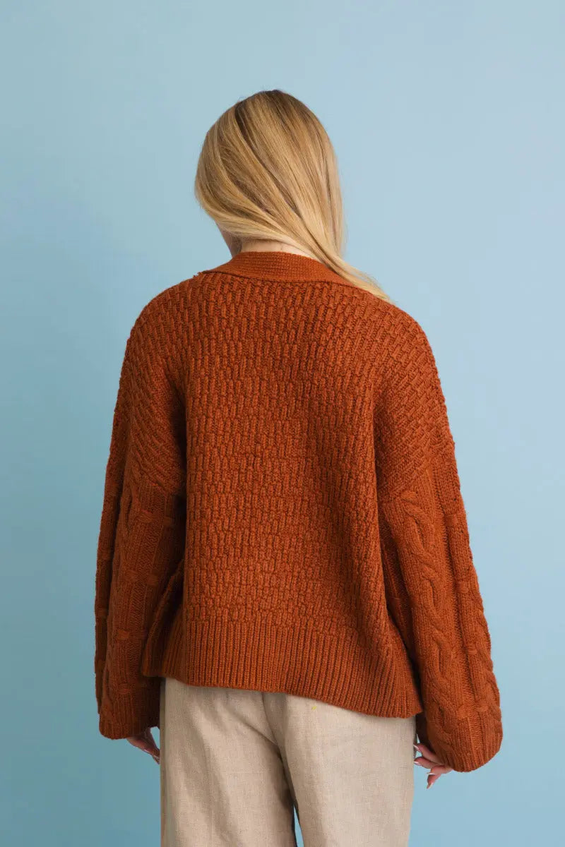 Brown/orange textured knit cardigan with button placket; back view.