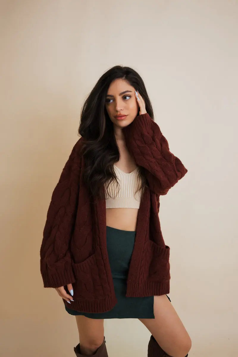 Burgundy cable-knit open cardigan with long sleeves and chunky cable texture