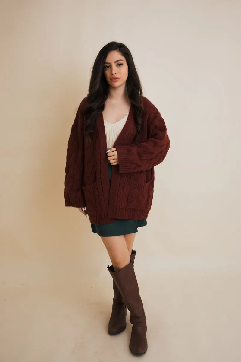 Burgundy cable-knit open cardigan with long sleeves, front pockets, and cable texture