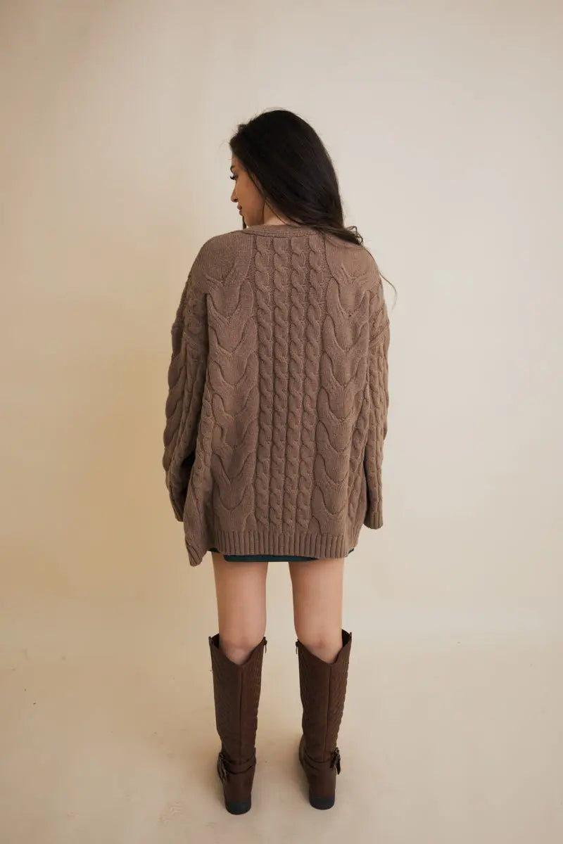 Brown cable knit open cardigan with chunky cable pattern, long sleeves, ribbed cuffs