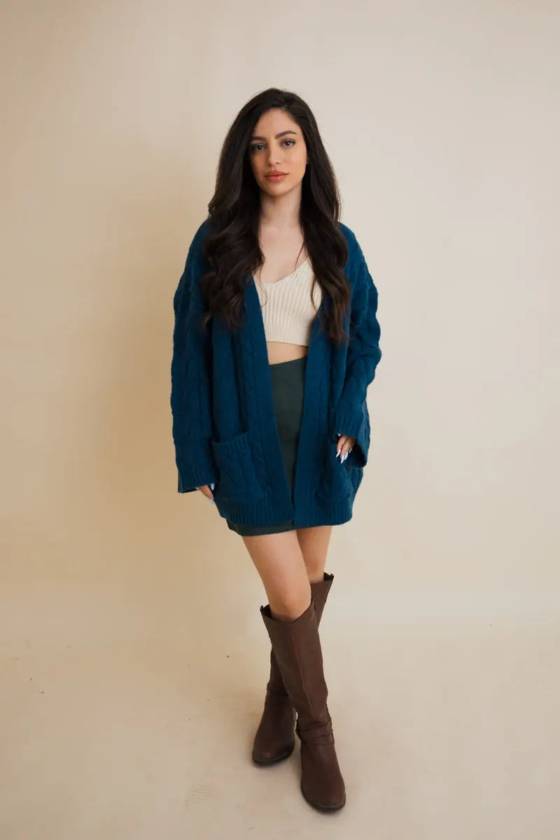 Teal cable-knit open cardigan with long sleeves and textured cable knit