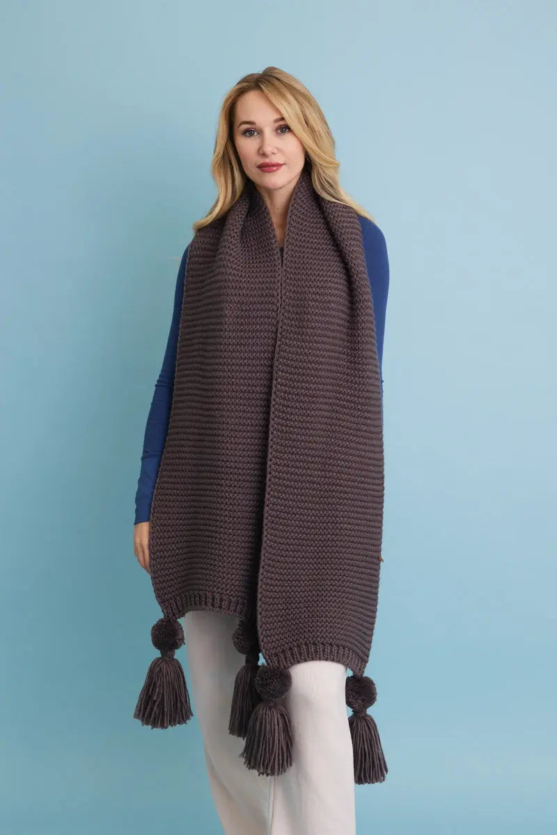 Brown knit scarf with tassel pom-poms on both sides