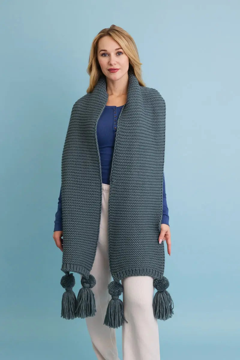 Slate gray chunky knit scarf with tassel pom-poms at the ends