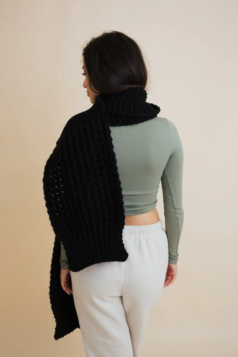 Black waffle-knit scarf from the back, thick chunky texture and drape