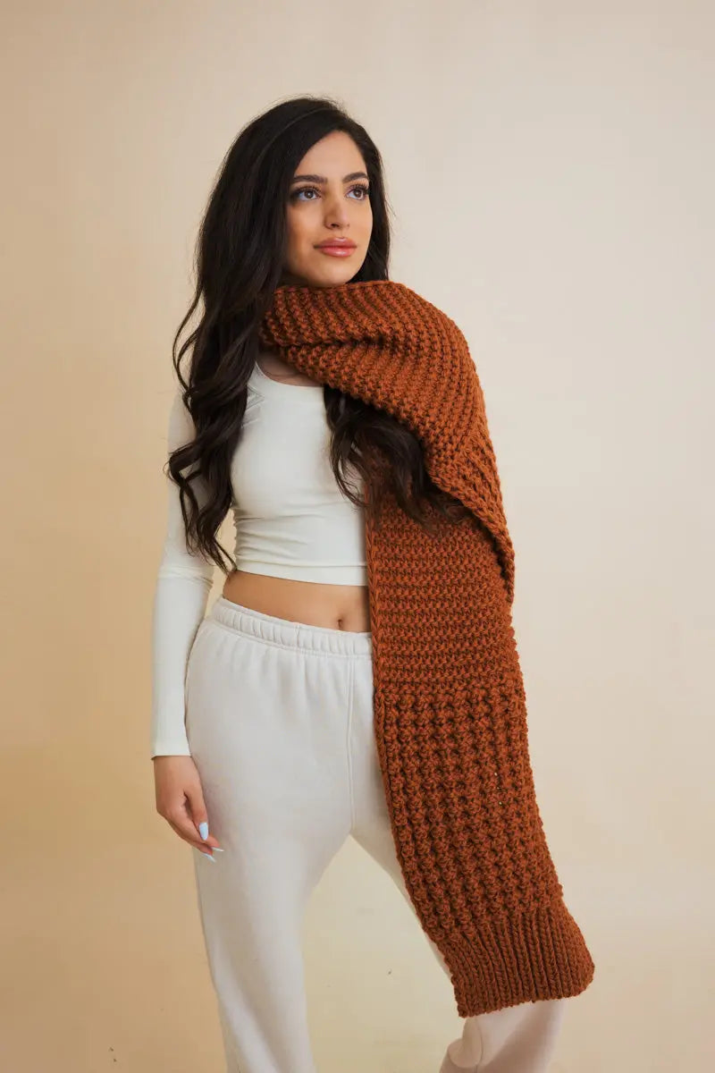 Brown waffle-knit edge scarf draped over shoulders, long chunky texture