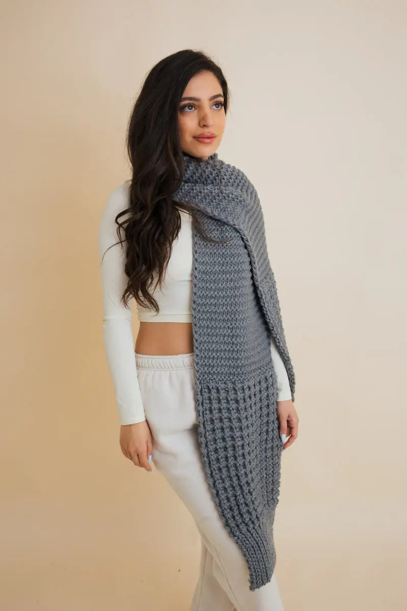Blue-gray waffle-knit cozy edge scarf worn as long wrap with textured weave