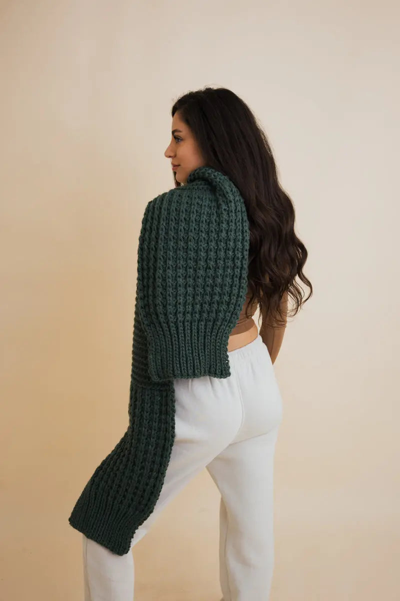 Dark green chunky knit scarf with ribbed texture, worn from the side