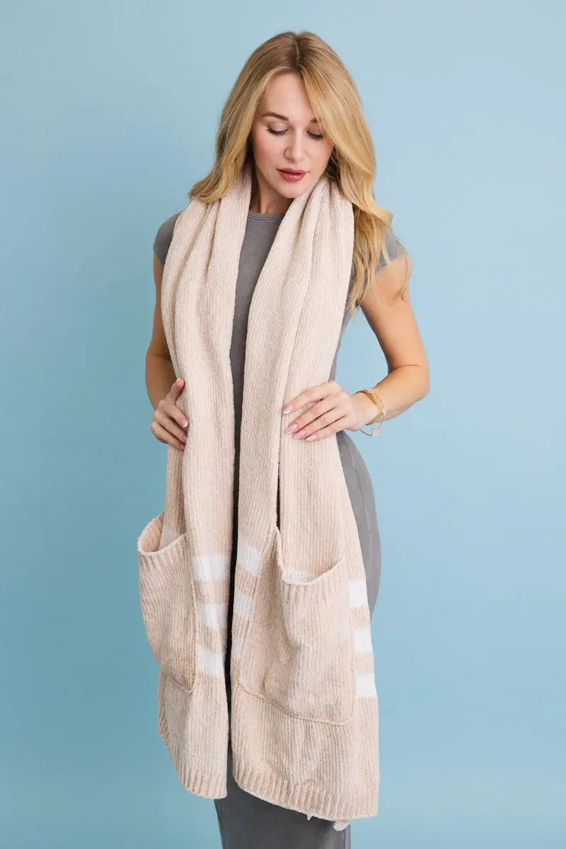 Beige chenille pocket scarf with two front patch pockets and striped trim at ends.