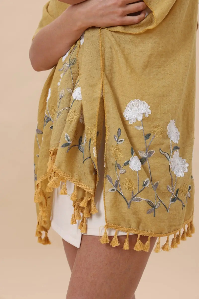 Mustard floral embroidered kimono cardigan close-up with white flower applique and tassels