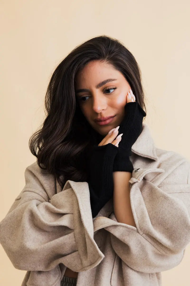 Black open-finger winter mittens with textured knit and exposed fingertips for phones