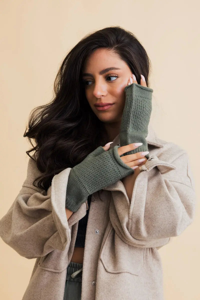 Olive open-finger winter mittens covering hands with exposed finger tips for phones
