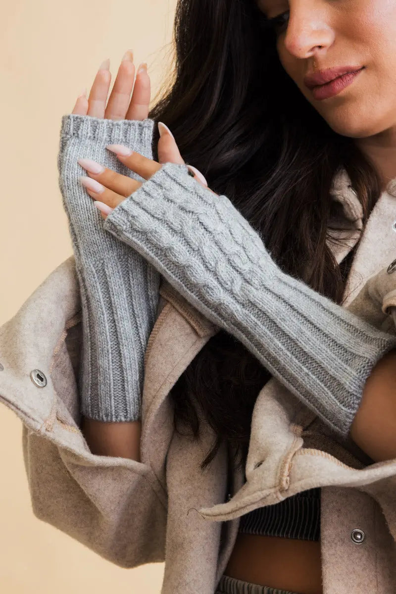 Gray cable-knit fingerless gloves with ribbed cuffs and braided cable pattern