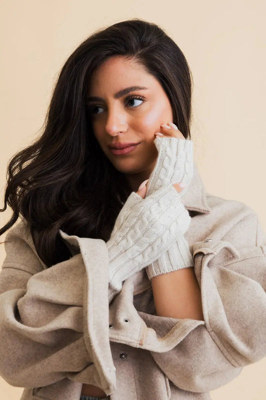 Ivory cable-knit fingerless gloves with ribbed cuffs and braided texture