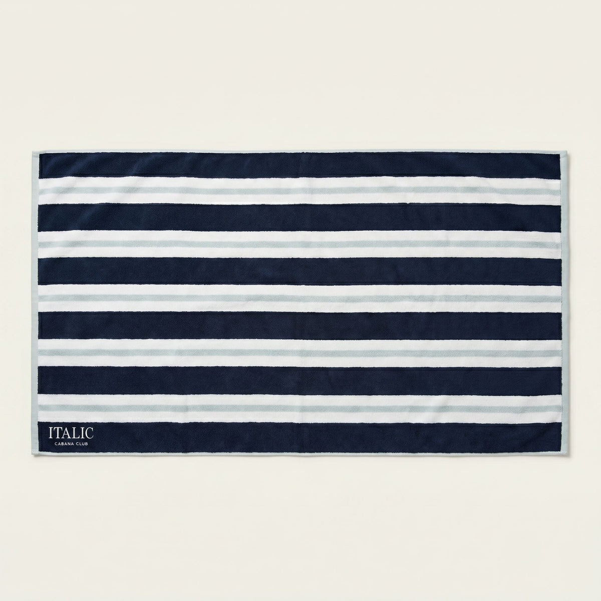 Navy and white striped cotton beach towel rectangle with border and ITALIC label