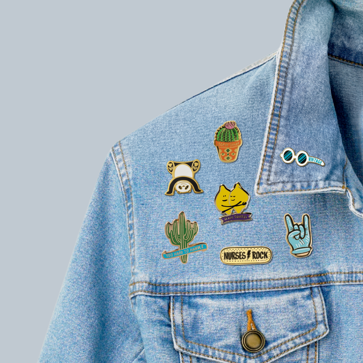 Cactus enamel pin on a blue denim jacket pocket area, gold-tone backing visible