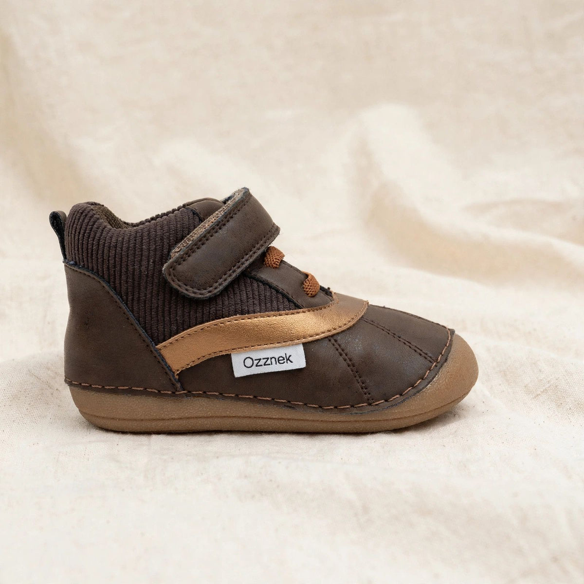 Kids barefoot boot side view, dark brown upper, tan stripe, hook-and-loop closure