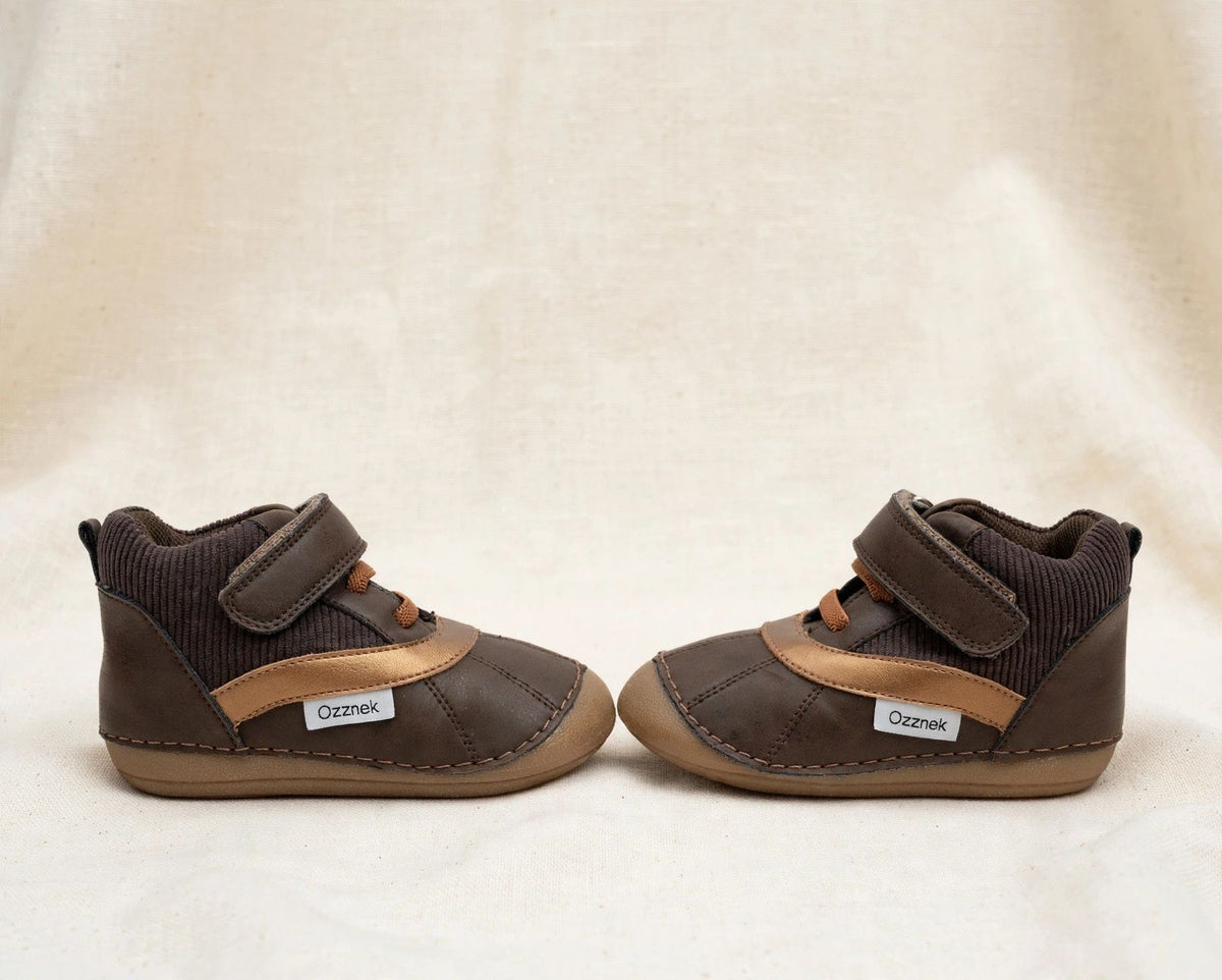 Kids barefoot boots front side view, dark brown and tan, hook-and-loop straps, elastic