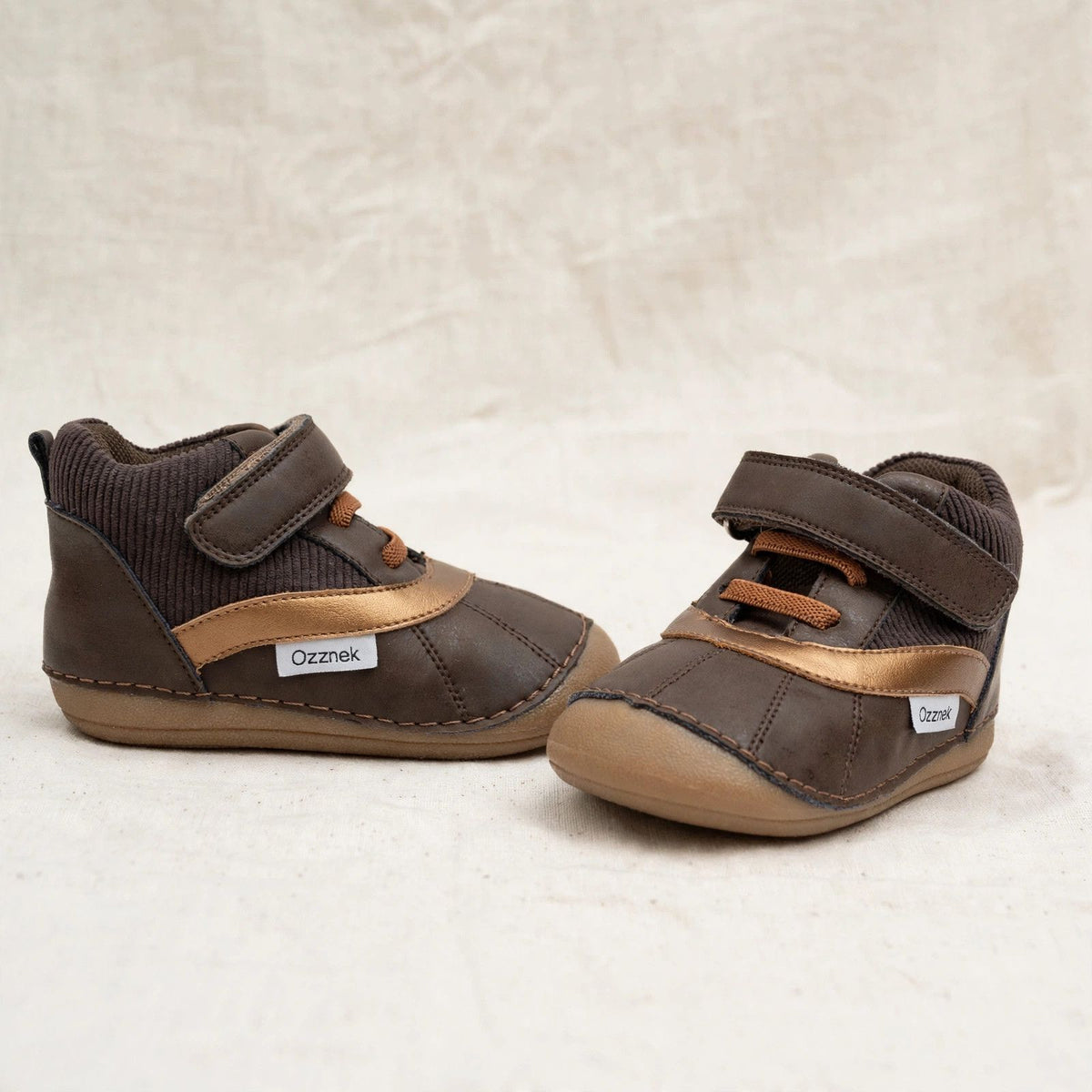 Kids barefoot boots pair, dark brown with tan accents, hook-and-loop straps, soft sole