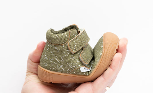 Olive toddler boots with speckled fabric, double hook-and-loop straps, sherpa lining.
