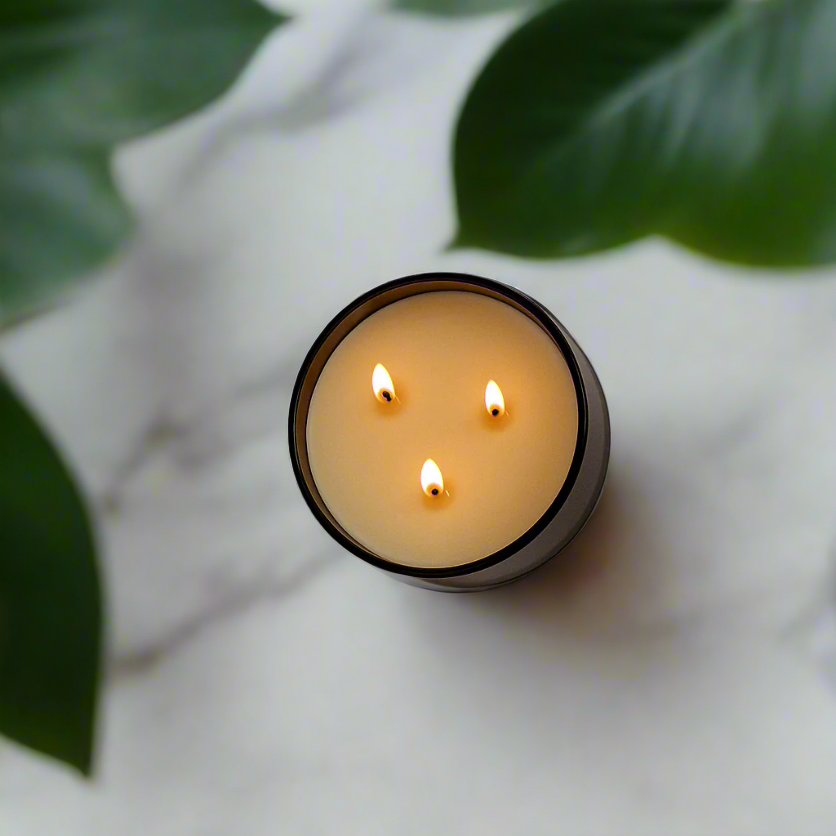 Brown 3-wick soy candle with three flames visible through jar opening