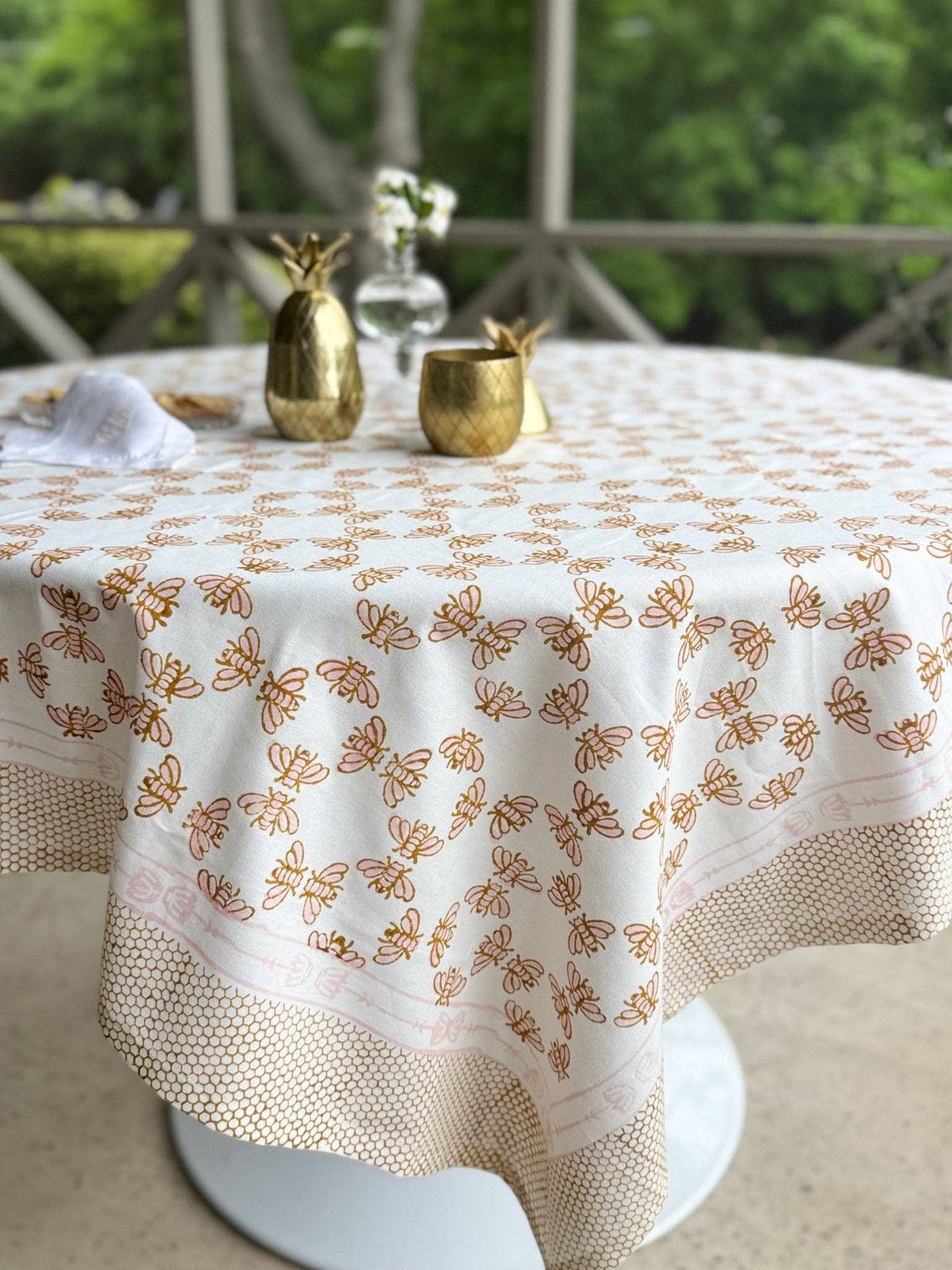 White table throw with honeybee and honeycomb motifs, rose and mustard