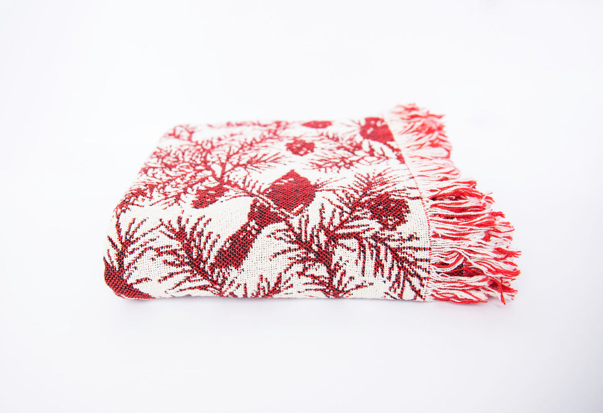 Cranberry red and cream jacquard woven throw with cardinal motifs and fringe edge
