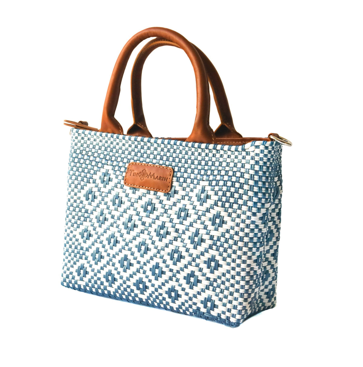 Woven crossbody bag with blue-and-white weave and tan leather top handles, front logo patch