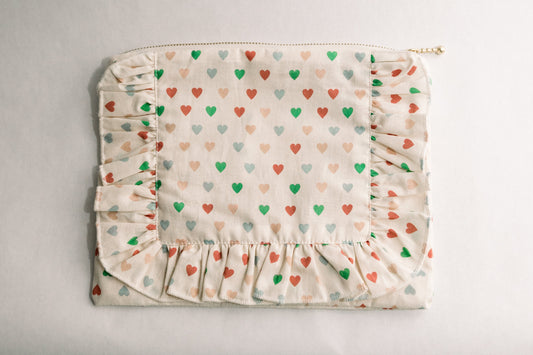 Heart-print ruffle zipper pouch with multicolor hearts and gathered bottom ruffle