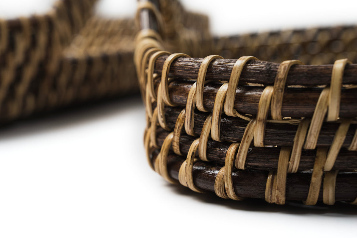 Close-up of braided woven rim on a dark brown and tan rectangle tray