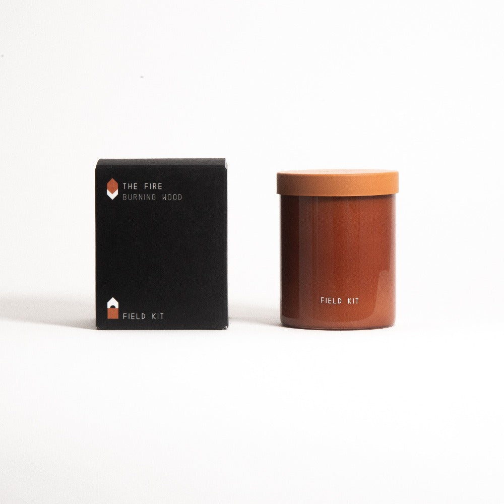 Scented candle in amber jar with orange lid, with matching product box