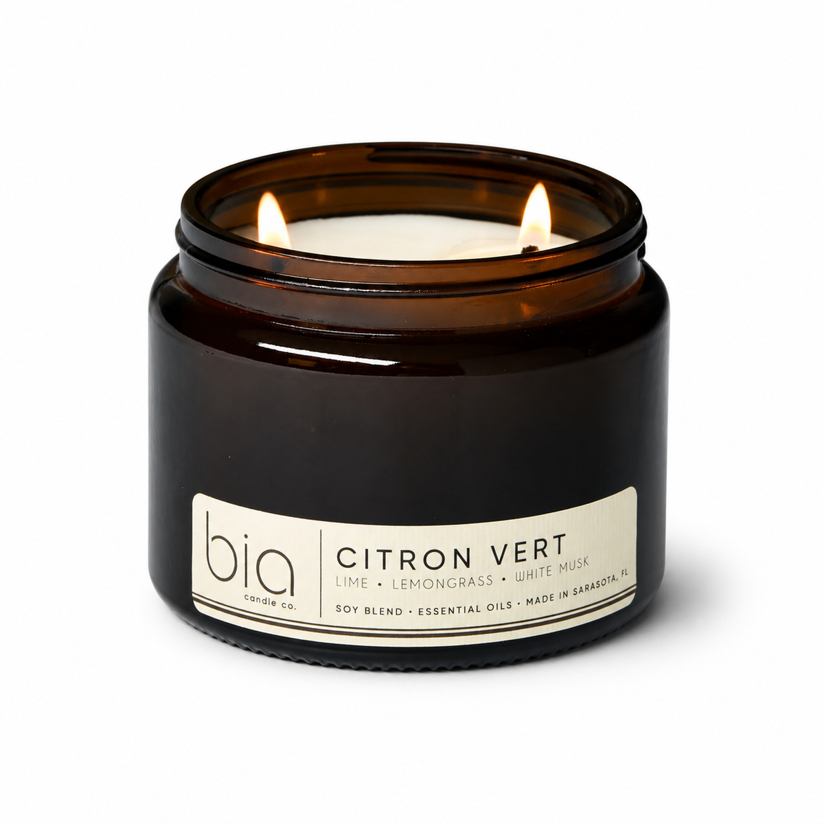 Amber glass soy blend candle with flame and front label reading Citron Vert