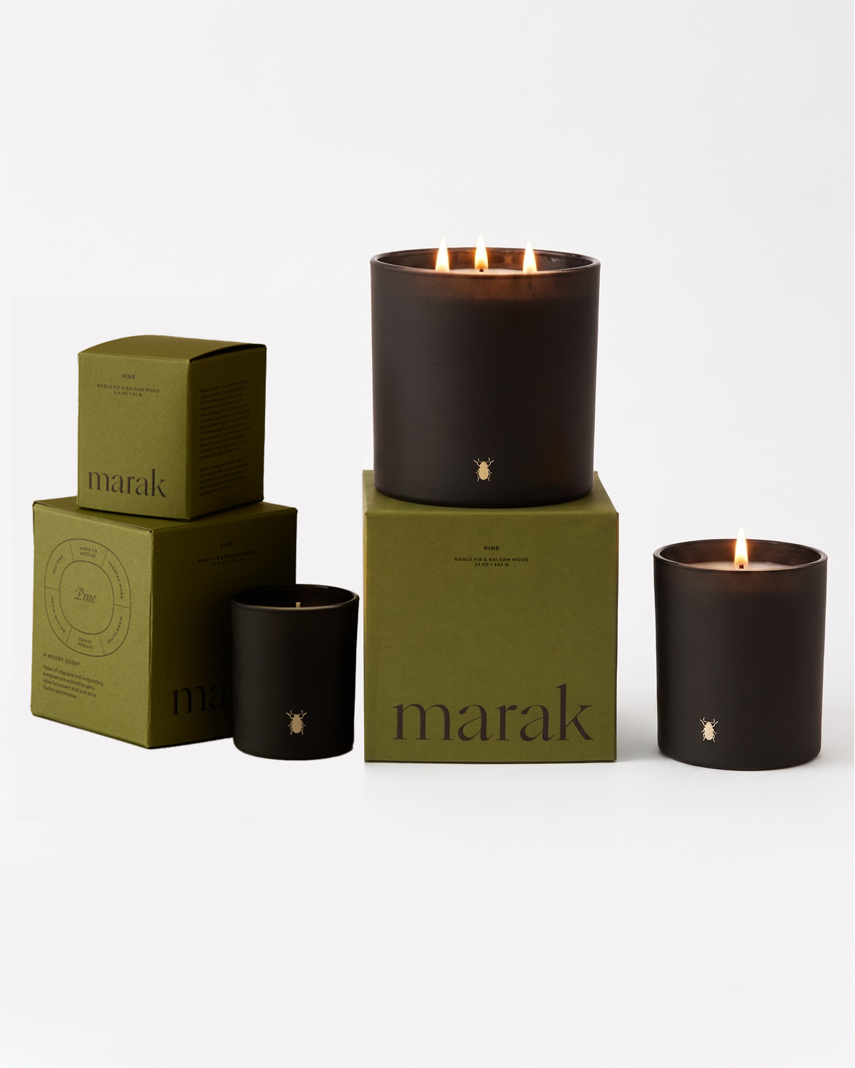 Black jar candles with flames and green marak boxes