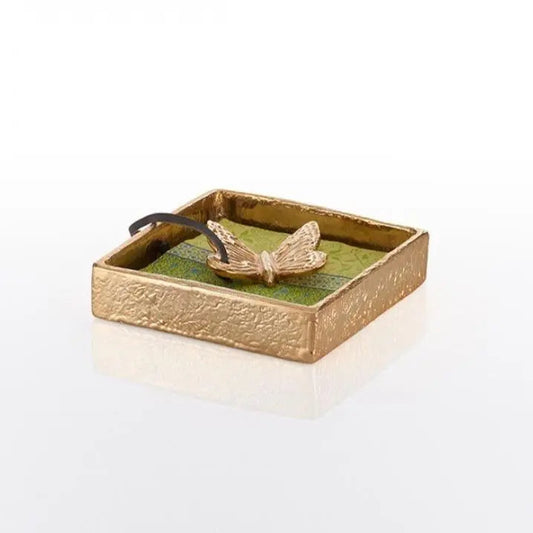 Gold cocktail napkin holder with raised nest and bird motif in open tray