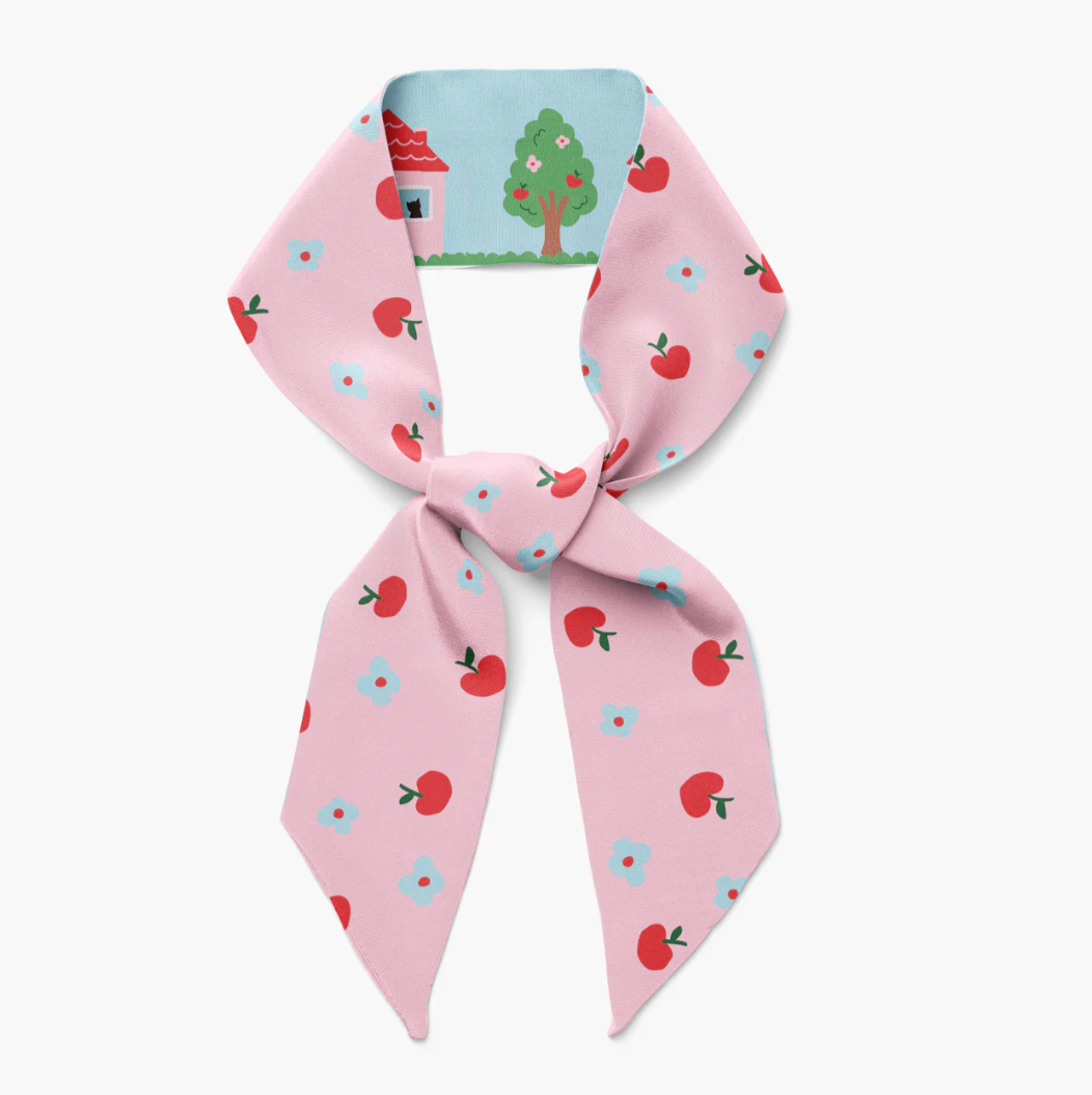 Pink twilly ribbon scarf with red cherries, blue flowers, and green tree house print
