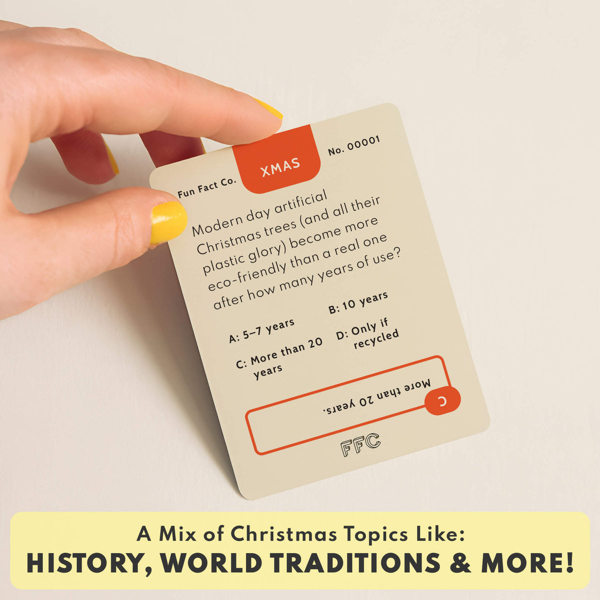 XMAS trivia card held in a hand with multiple-choice question and answer