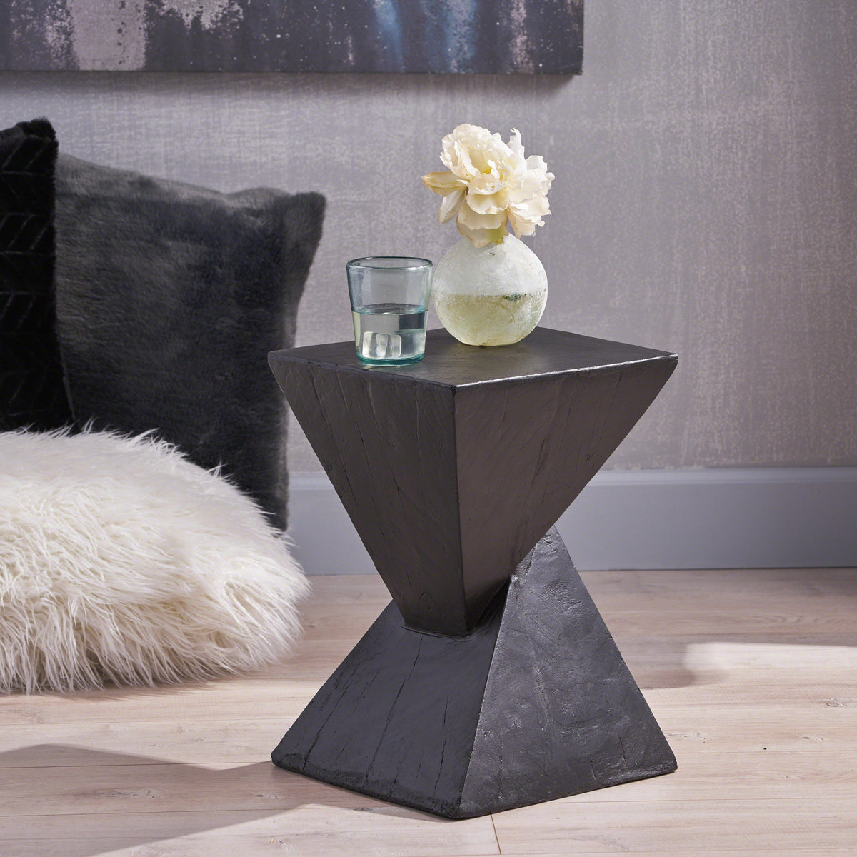 Black side table with a square top and flared hourglass base