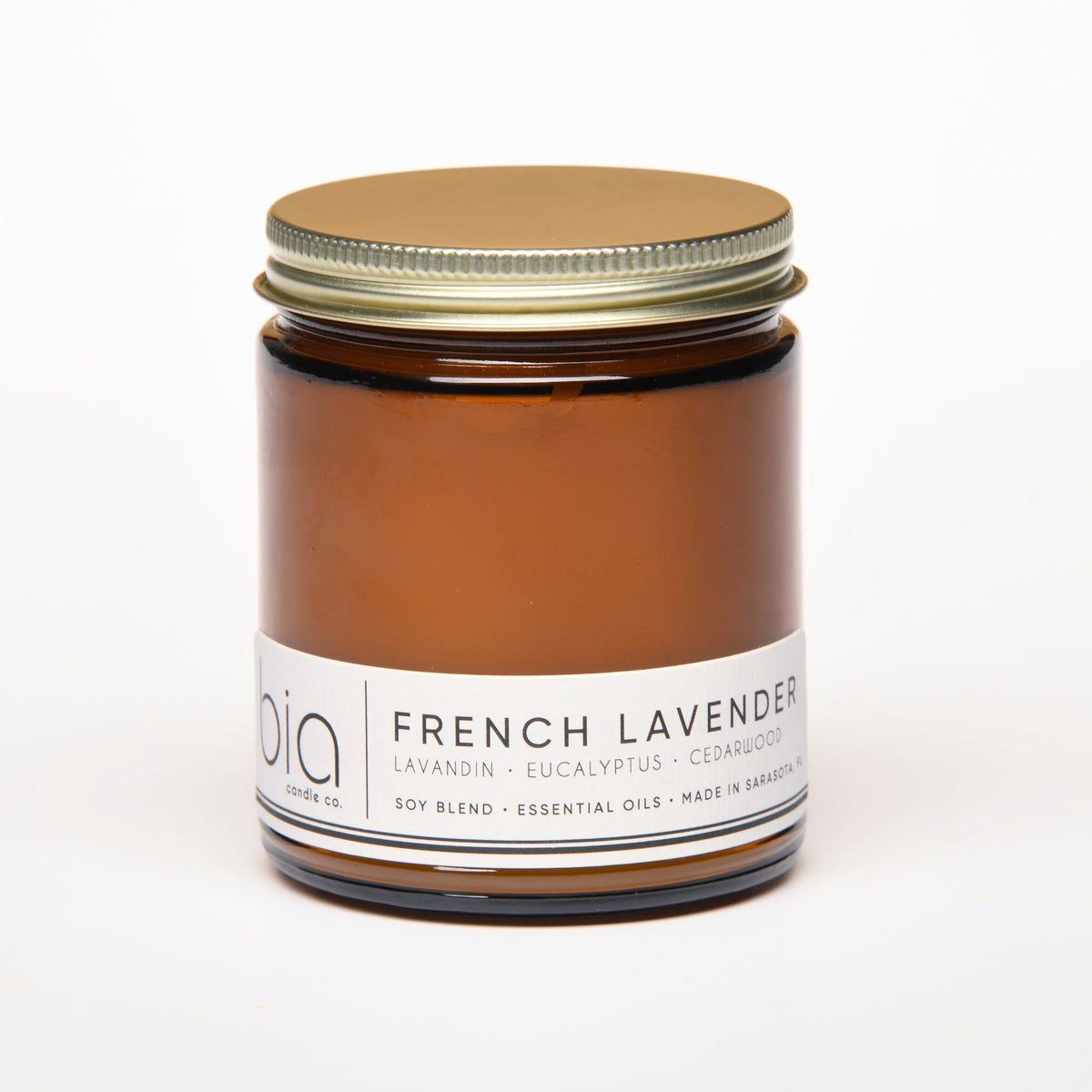 Amber soy candle jar with gold lid, front label visible
