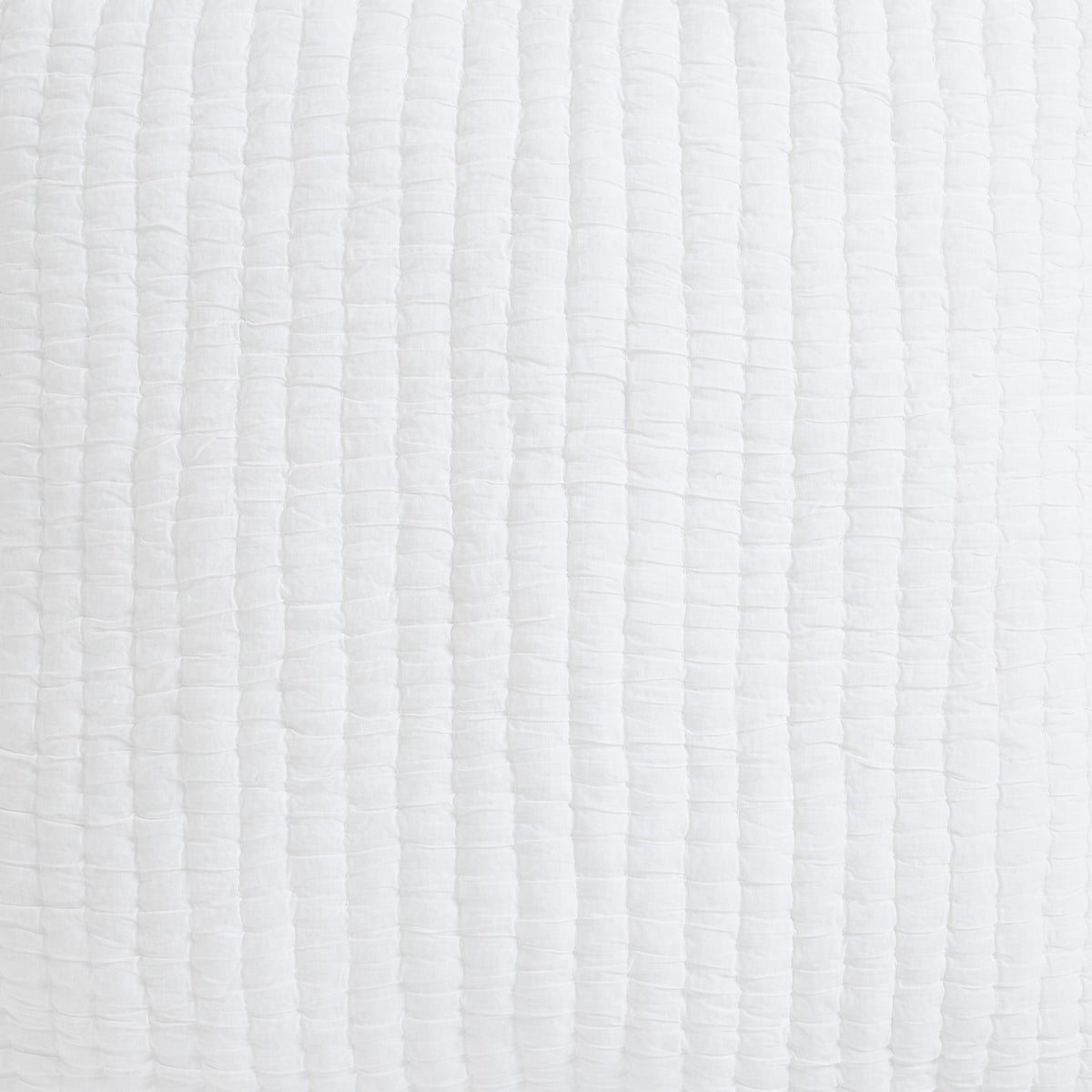 White quilt fabric close-up with vertical quilted crinkle stitch pattern