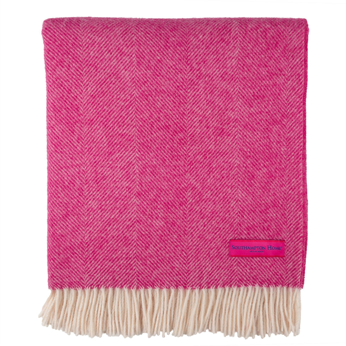 Pink herringbone throw with cream fringe and 'Southampton Home' label