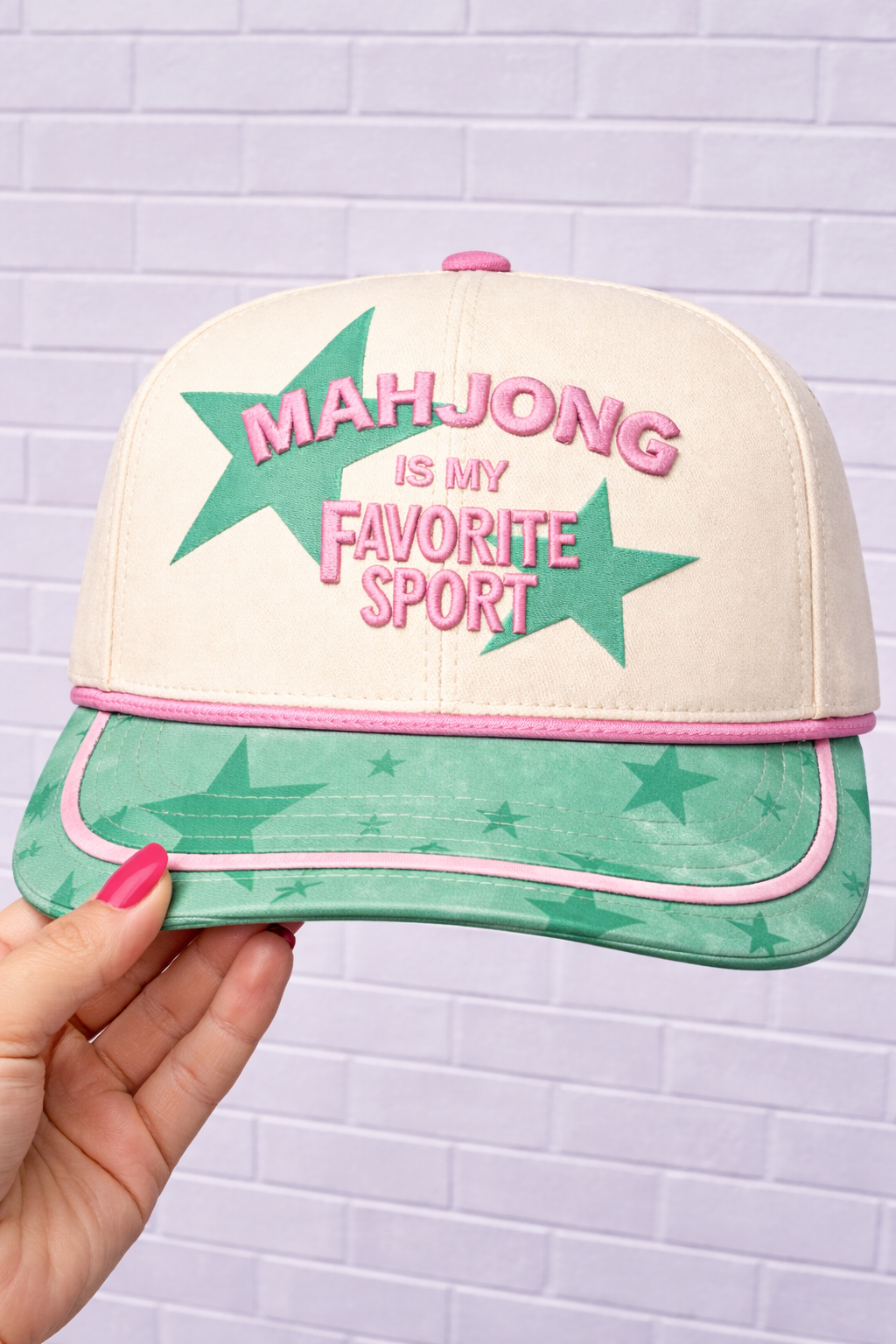 Cream baseball cap with green star graphic and pink "Mahjong is my favorite sport" text.