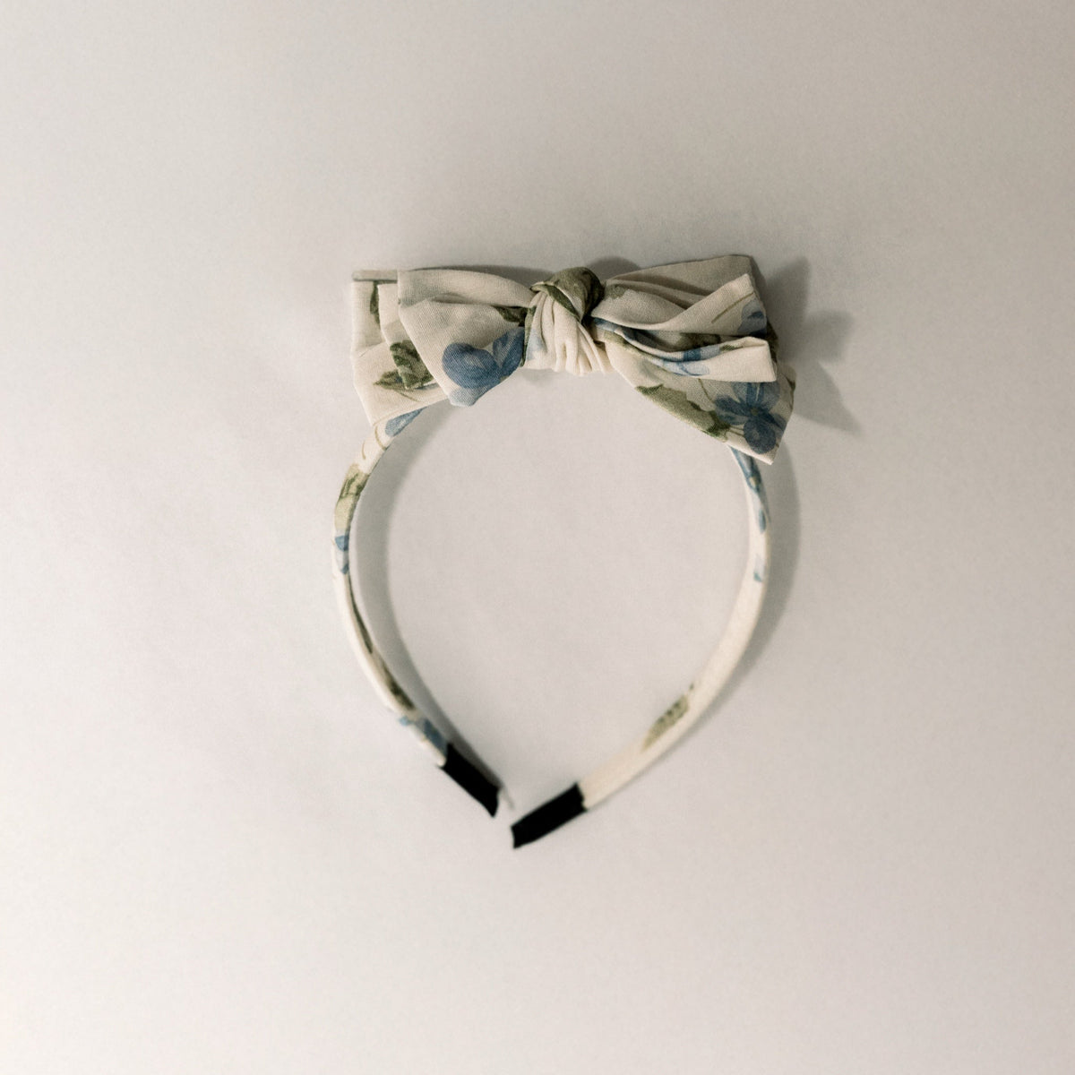 Cream headband with three-tier bow top and cornflower blue dot accents