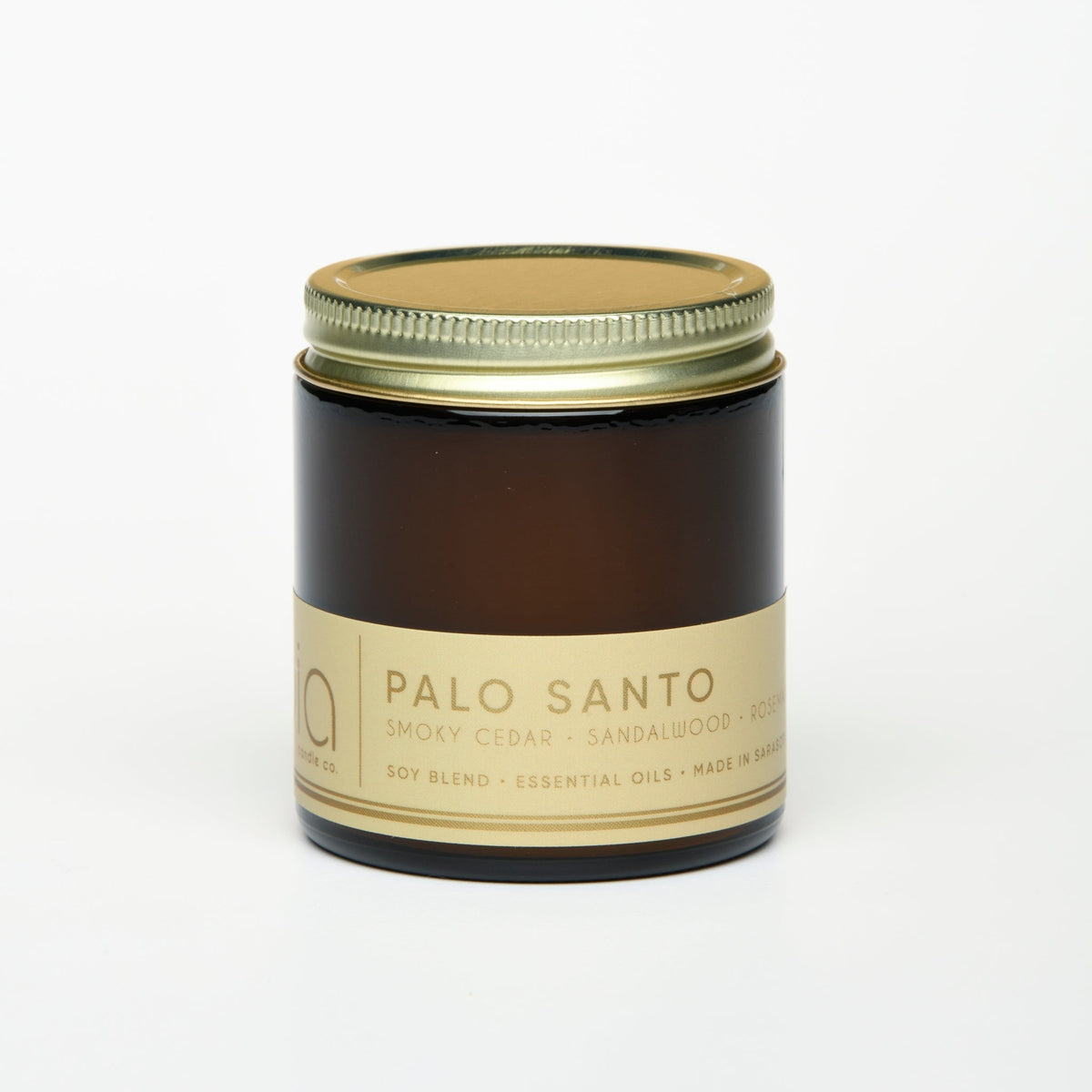 Brown glass soy candle jar with gold lid and cream label, unlit