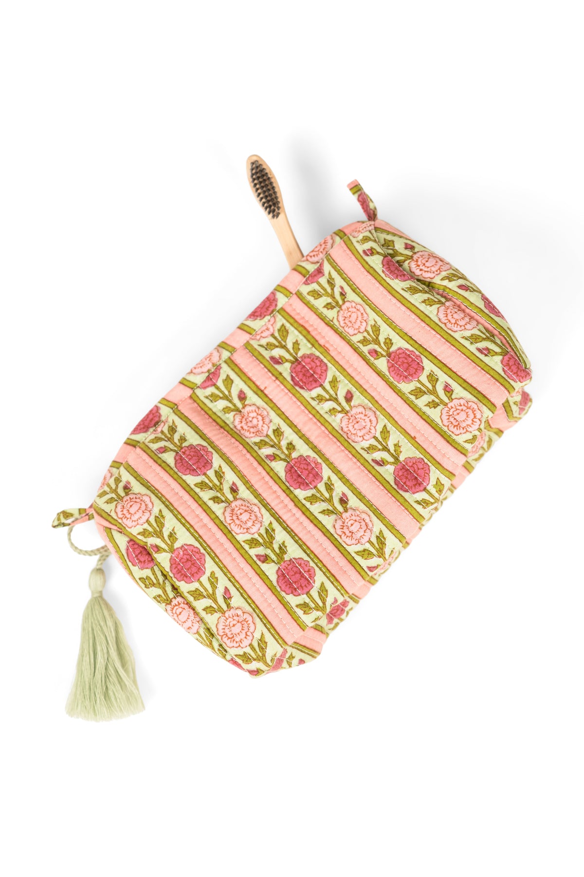 Striped makeup bag with tassel trim and zip top in pink rose tones