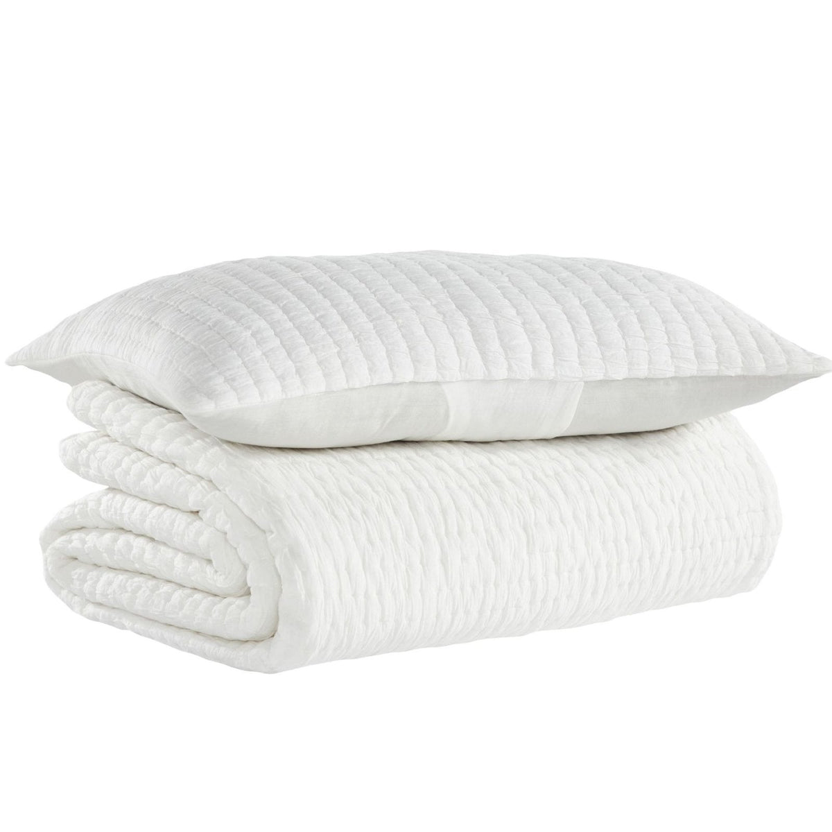 Washed cotton quilt in light white tones, folded with stitched channels and soft texture