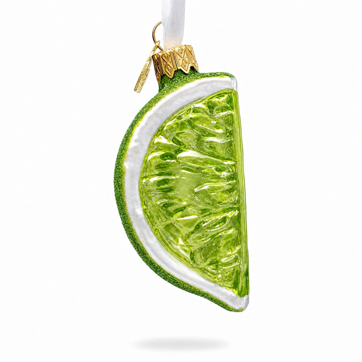 Green glitter lime-slice glass ornament with gold hanger and white rind rim.