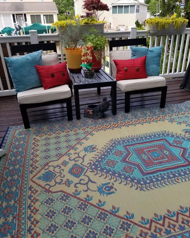 Turkish-style area rug on patio with blue, teal, and red medallion pattern