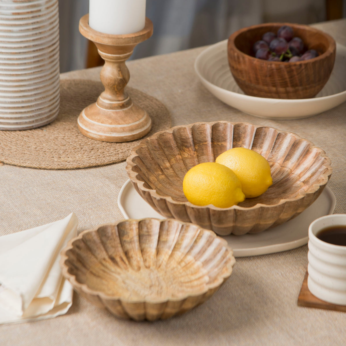 Natural scalloped wooden bowl with lemons, plus a second smaller scalloped bowl