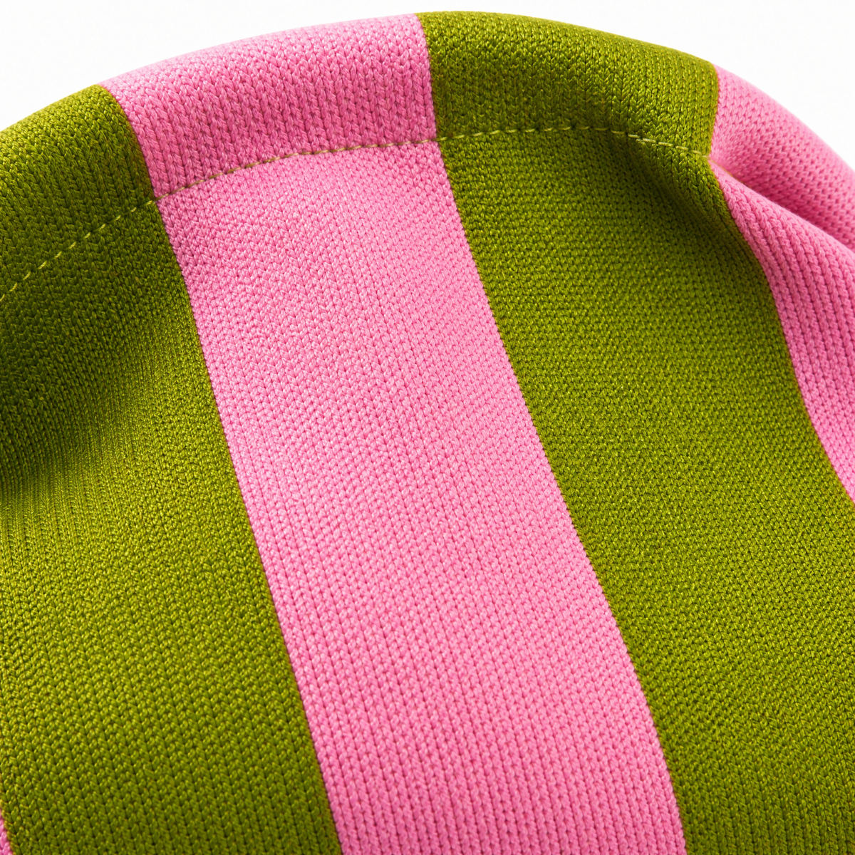 Close-up of green and pink striped woven clutch fabric